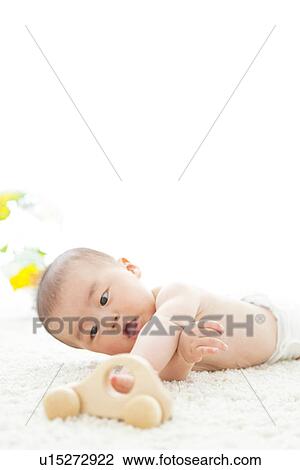 Baby boy playing with a toy car View Large Photo Image Stock Image - Baby boy playing with a toy car. Fotosearch