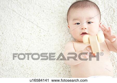 Baby boy playing with a toy car View Large Photo Image Stock Image - Baby boy playing with a toy car. Fotosearch