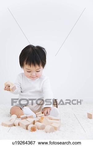 Baby boy playing with blocks View Large Photo Image Stock Photo - Baby boy playing with blocks. Fotosearch