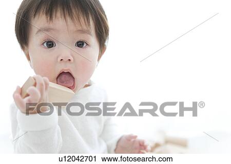Baby boy putting block in his mouth View Large Photo Image Stock Image - Baby boy putting block in his mouth. Fotosearch