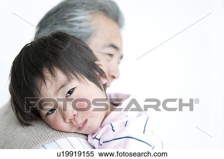Baby boy resting his head on his grandfather's shoulder View Large Photo Image Stock Photography - Baby boy resting his head on his grandfather's shoulder. Fotosearch