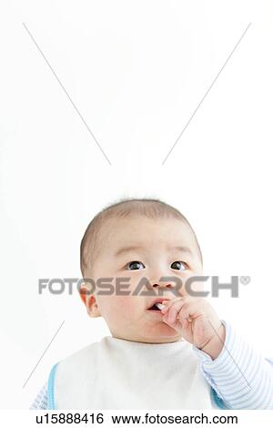 Stock Photograph - Baby eating with a spoon. Fotosearch