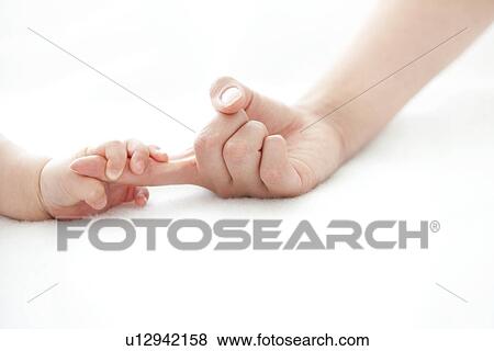 Stock Photo - Baby holding adult's finger. Fotosearch