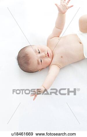 Baby lying on back View Large Photo Image Stock Photo - Baby lying on back. Fotosearch