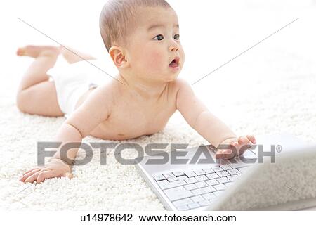 Baby playing with a laptop View Large Photo Image Stock Image - Baby playing with a laptop. Fotosearch
