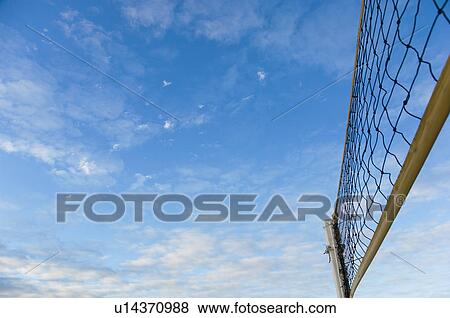 Beach volleyball net under blue sky with clouds View Large Photo Image Stock Photo - Beach volleyball net under blue sky with clouds. Fotosearch