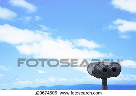 Binoculars and a blue sky next to sea View Large Photo Image Stock Photograph - Binoculars and a blue sky next to sea. Fotosearch