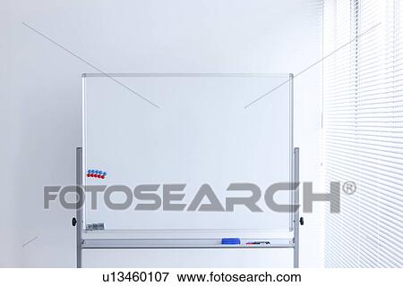 Blank whiteboard in empty office room View Large Photo Image Stock Photo - Blank whiteboard in empty office room. Fotosearch