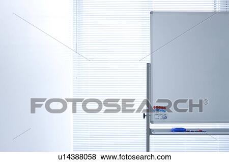 Stock Photo - Blank whiteboard in empty office room. Fotosearch