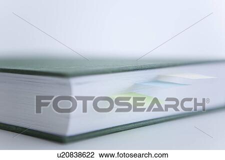 Stock Image - Book with adhesive notes. Fotosearch
