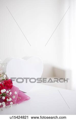 Bouquet of carnations and baby's breath with a heart shaped gift box View Large Photo Image Stock Image - Bouquet of carnations and baby's breath with a heart shaped gift box. Fotosearch