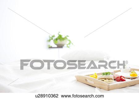 Stock Image - Breakfast on a bed. Fotosearch