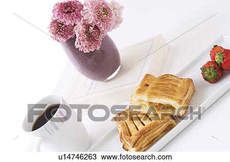 Stock Image - Breakfast setting with pastry and coffee. Fotosearch