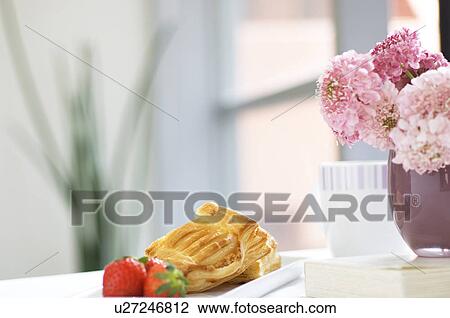 Stock Image - Breakfast setting with pastry and coffee. Fotosearch