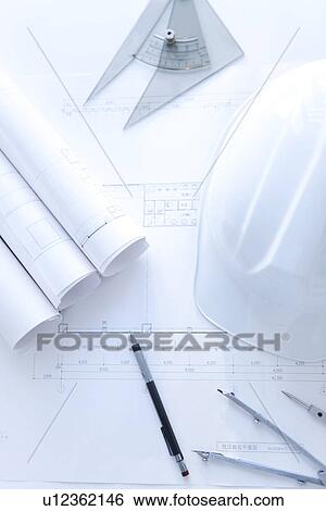Stock Photograph - Building plan drawing equipment and a hardhat. Fotosearch