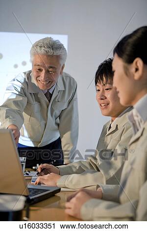 Stock Image - Business colleagues in boardroom. Fotosearch