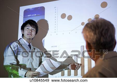 Stock Photo - Business colleagues in boardroom. Fotosearch