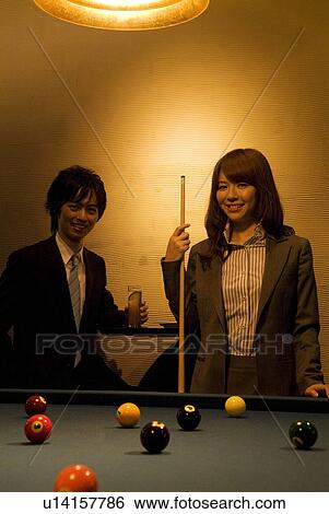 Stock Photograph - Business colleagues playing pool. Fotosearch