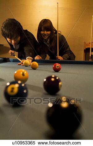Stock Photography - Business colleagues playing pool. Fotosearch