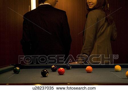 Business colleagues standing next to a pool table View Large Photo Image Stock Photography - Business colleagues standing next to a pool table. Fotosearch