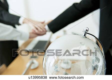 Stock Photo - Business partners with hands together. Fotosearch