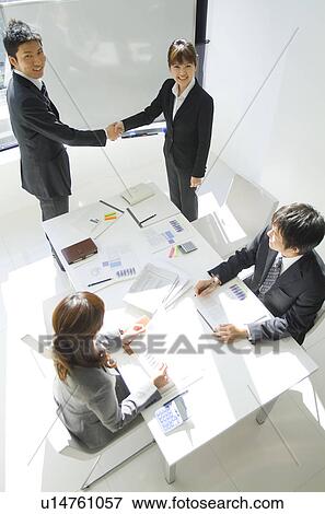 Businessman and a businesswoman shake hands in a conference View Large Photo Image Stock Photo - Businessman and a businesswoman shake hands in a conference. Fotosearch
