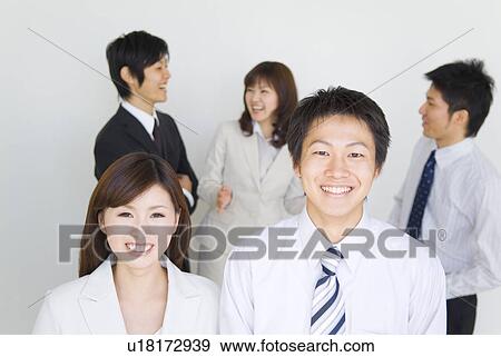 Businessman and businesswoman smiling at the camera View Large Photo Image Stock Photo - Businessman and businesswoman smiling at the camera. Fotosearch