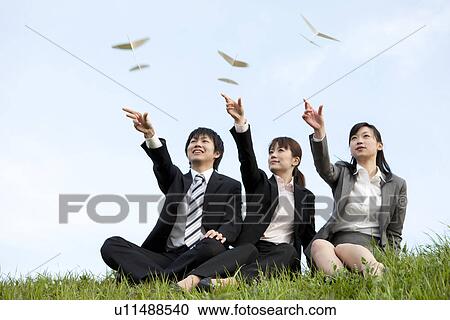 Businessman and businesswomen playing with paper planes View Large Photo Image Stock Image - Businessman and businesswomen playing with paper planes. Fotosearch