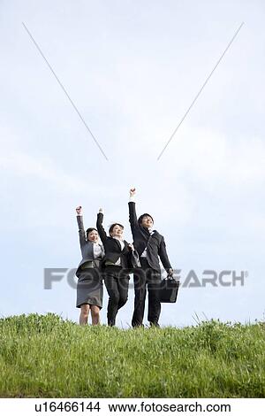 Picture - Businessman and businesswomen punching air. Fotosearch