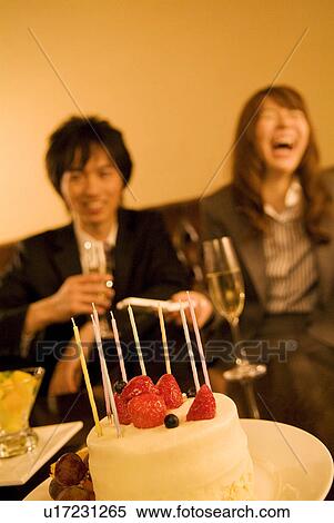 Businessman and woman celebrating with cake and champagne View Large Photo Image Stock Photography - Businessman and woman celebrating with cake and champagne. Fotosearch
