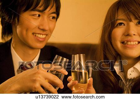 Stock Image - Businessman and woman drinking champagne. Fotosearch