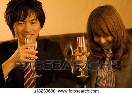 Stock Photo - Businessman and woman drinking champagne. Fotosearch