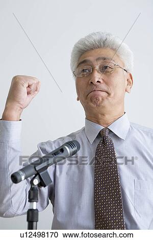 Stock Image - Businessman giving a presentation. Fotosearch
