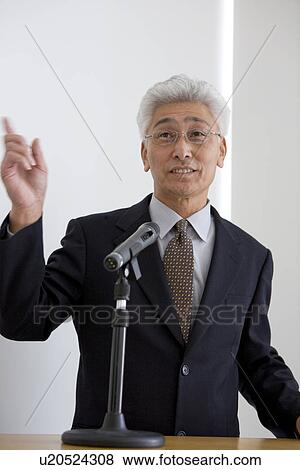 Businessman giving a presentation View Large Photo Image Stock Photo - Businessman giving a presentation. Fotosearch