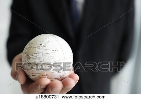 Businessman holding a globe View Large Photo Image Stock Image - Businessman holding a globe. Fotosearch