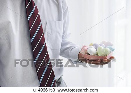 Businessman holding heart shaped soaps View Large Photo Image Stock Image - Businessman holding heart shaped soaps. Fotosearch