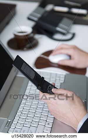 Businessman holding mobile phone View Large Photo Image Stock Image - Businessman holding mobile phone. Fotosearch