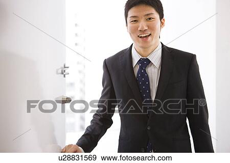 Businessman opening door View Large Photo Image Stock Photo - Businessman opening door. Fotosearch