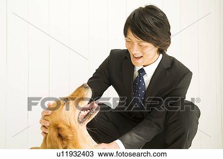 Businessman patting pet dog View Large Photo Image Stock Image - Businessman patting pet dog. Fotosearch