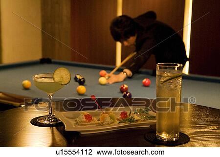 Stock Image - Businessman playing pool. Fotosearch