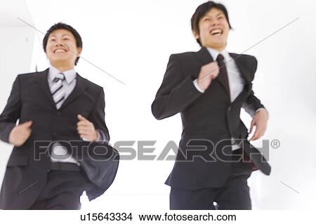 Businessman running and smiling View Large Photo Image Picture - Businessman running and smiling. Fotosearch