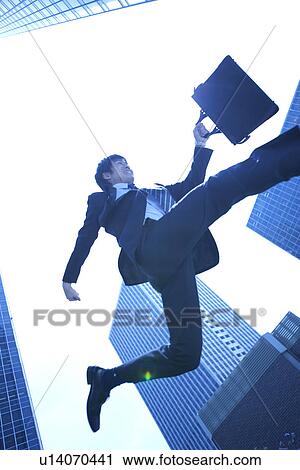 Stock Image - Businessman running in street. Fotosearch