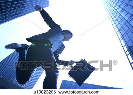 Stock Photography - Businessman running in street. Fotosearch