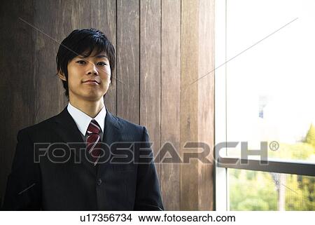 Picture - Businessman smiling at the camera. Fotosearch