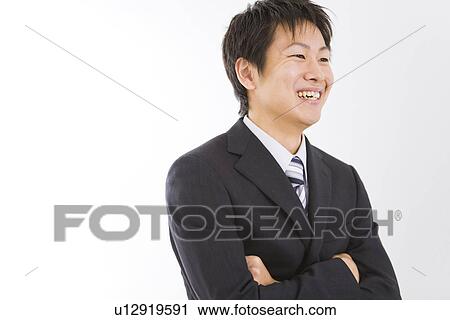 Stock Image - Businessman smiling with folded arms. Fotosearch