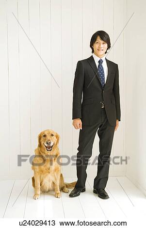 Businessman standing with dog View Large Photo Image Stock Image - Businessman standing with dog. Fotosearch