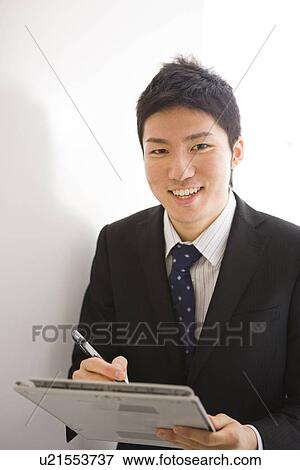 Stock Photo - Businessman taking a memo. Fotosearch