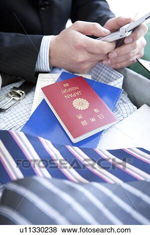 Stock Photo - Businessman text messaging. Fotosearch