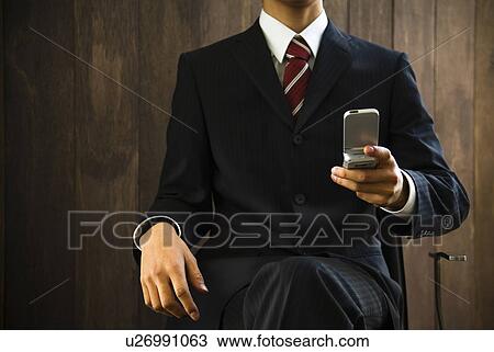 Businessman using a mobile phone View Large Photo Image Stock Image - Businessman using a mobile phone. Fotosearch