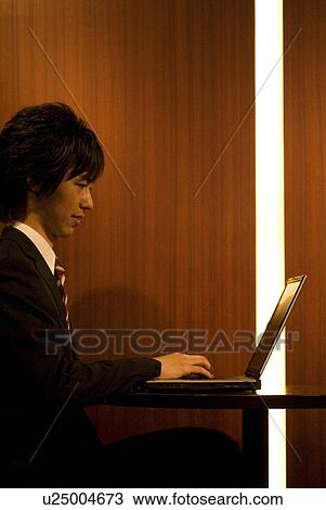 Stock Image - Businessman using laptop. Fotosearch